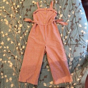 Girls jumpsuit never worn perfect condition.  Red whit stripe.